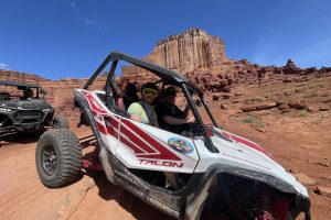 Guest getting a picture to prove they did Moab's most beautiful Chicken Corners / Catacomb Caves UTV side by side tour